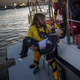 A volunteer carries a young boy. Oct. 28, 2015.